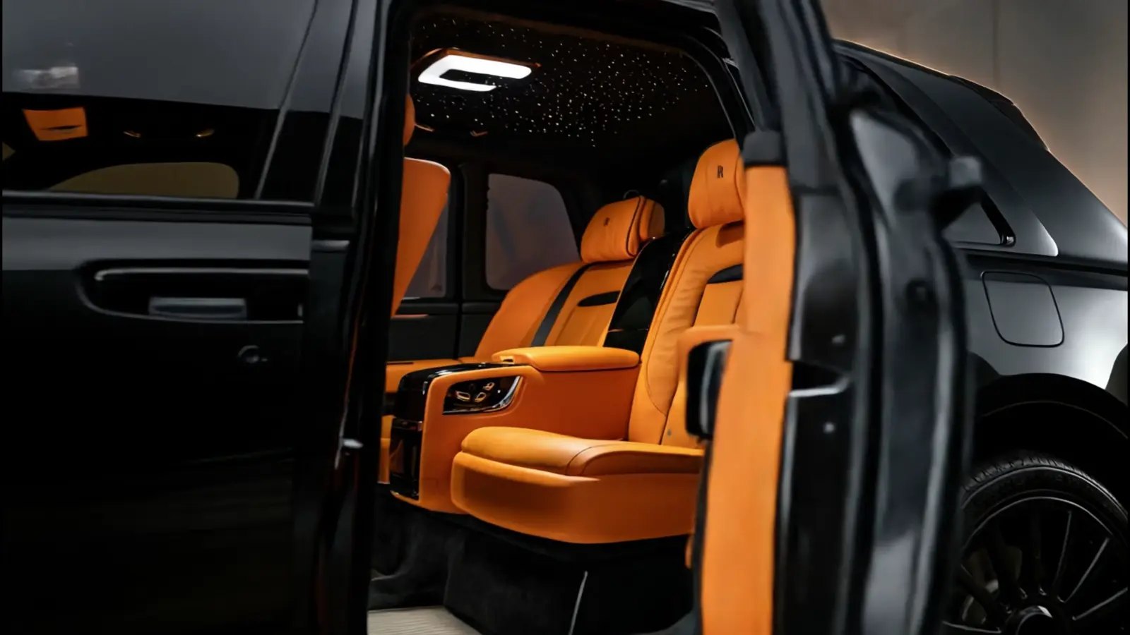 Rolls-Royce Cullinan with its rear coach door open at night